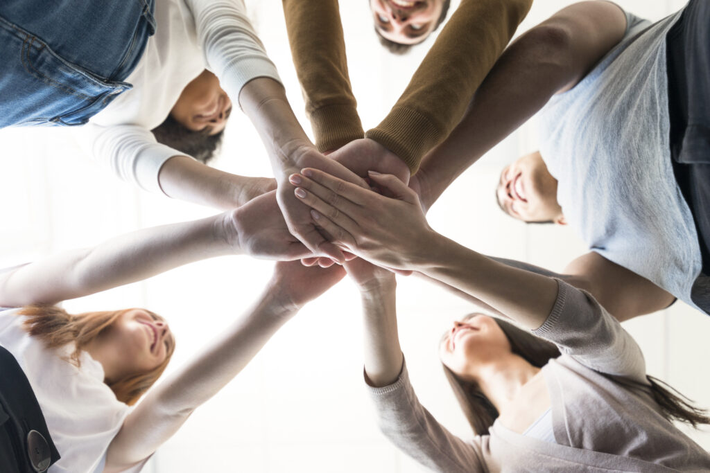 group young people holding hands
